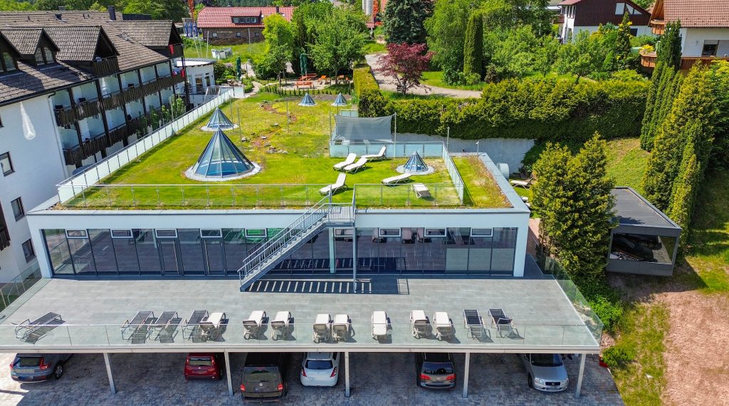 Aerial view of the Wellnesshotel Hohenrodt with the modern hotel building and the spacious wellness area, surrounded by the idyllic nature of the Black Forest