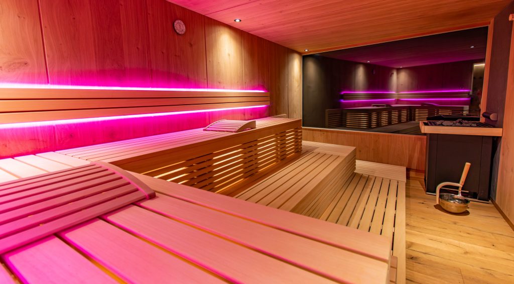Moderne Sauna mit pinker LED-Beleuchtung für ein besonderes Wellness-Erlebnis